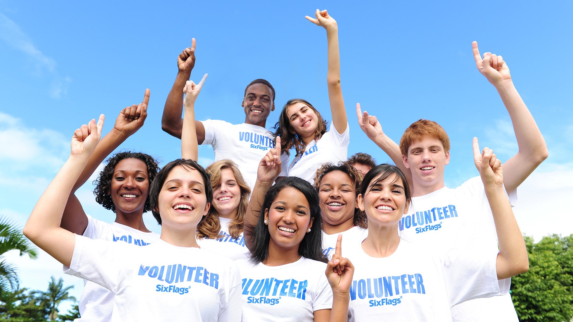 Group of volunteers smiling at the camera at Six Flags theme park