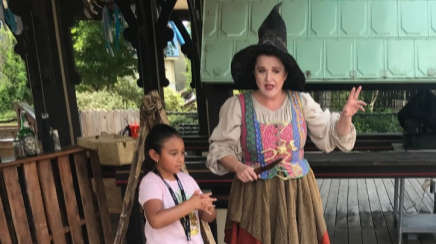 Bridgette Aye Notavittch tells a story to children at Six Flags Fiesta Texas