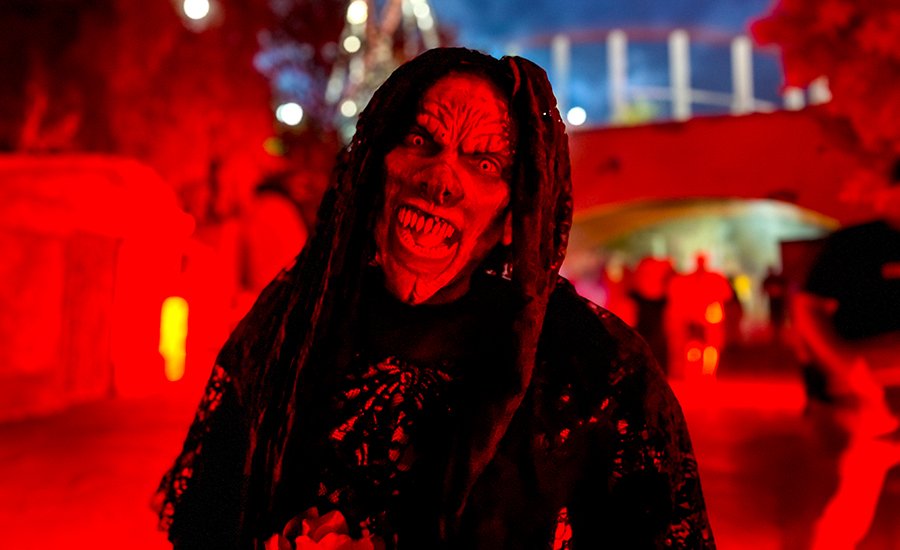 A scary ghoul lit with red lights at Six Flags Magic Mountain