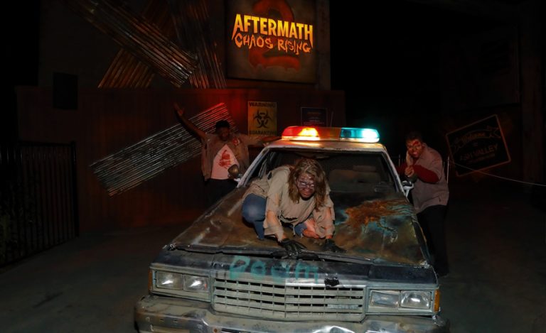 Zombies on old rusty car in from of aftermath of chaos