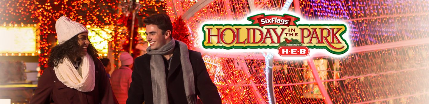 Couple walking through lights at Holiday in the Park