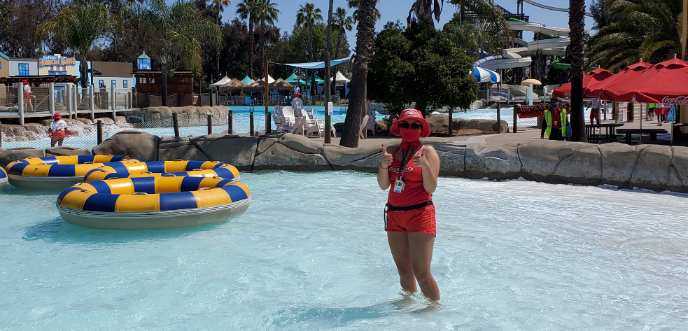 Lifeguard at Hurricane Harbor wearing and mask and giving a thumbs up